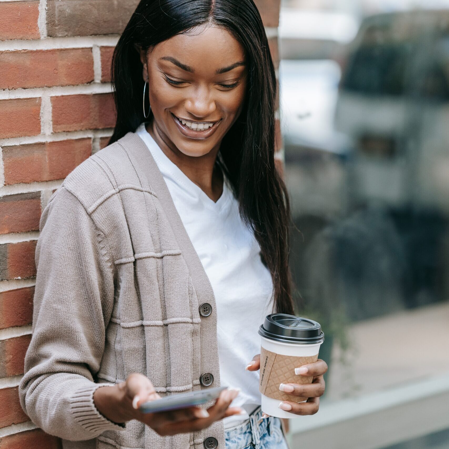 Woman looking at a mobile phone in her hand and smiling