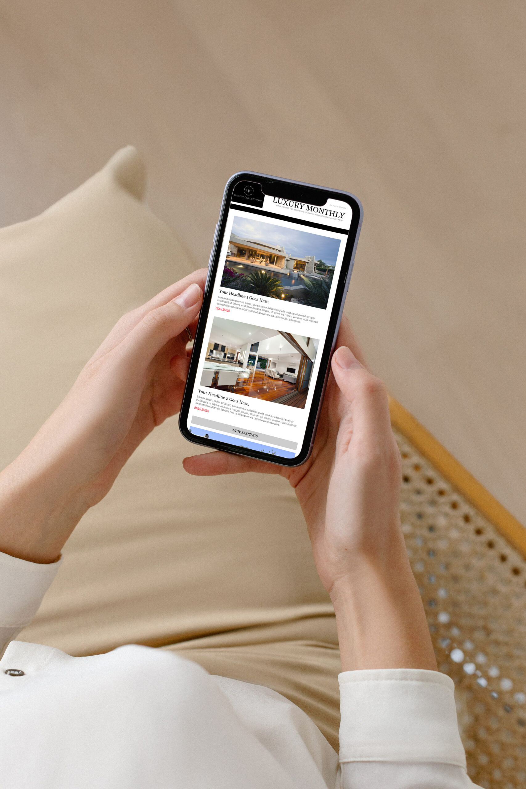 person holding mobile phone viewing luxury real estate newsletter on screen