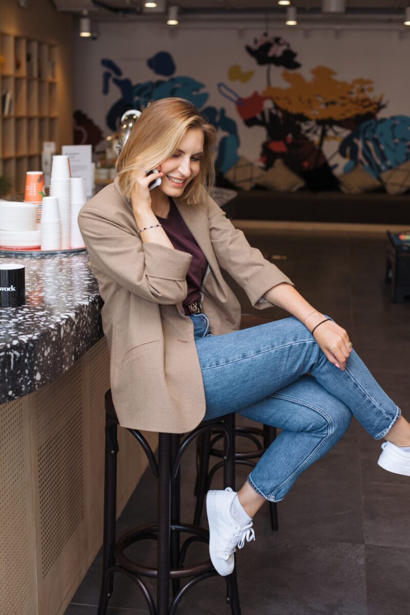 woman talking on phone in a cafe